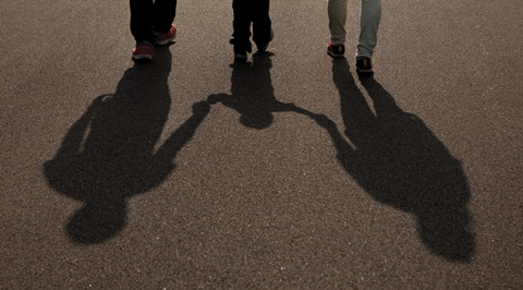 The picture shows the shadow of a couple and their child