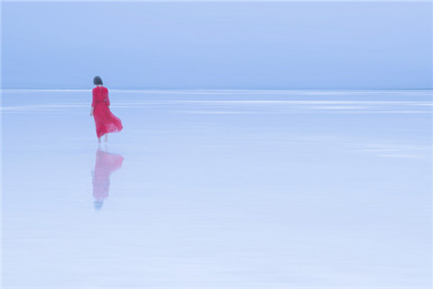 The picture shows a figure of a woman in red