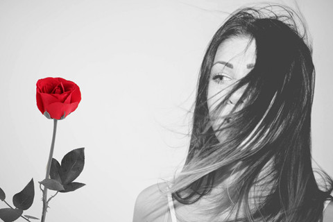 The picture shows a girl and a rose